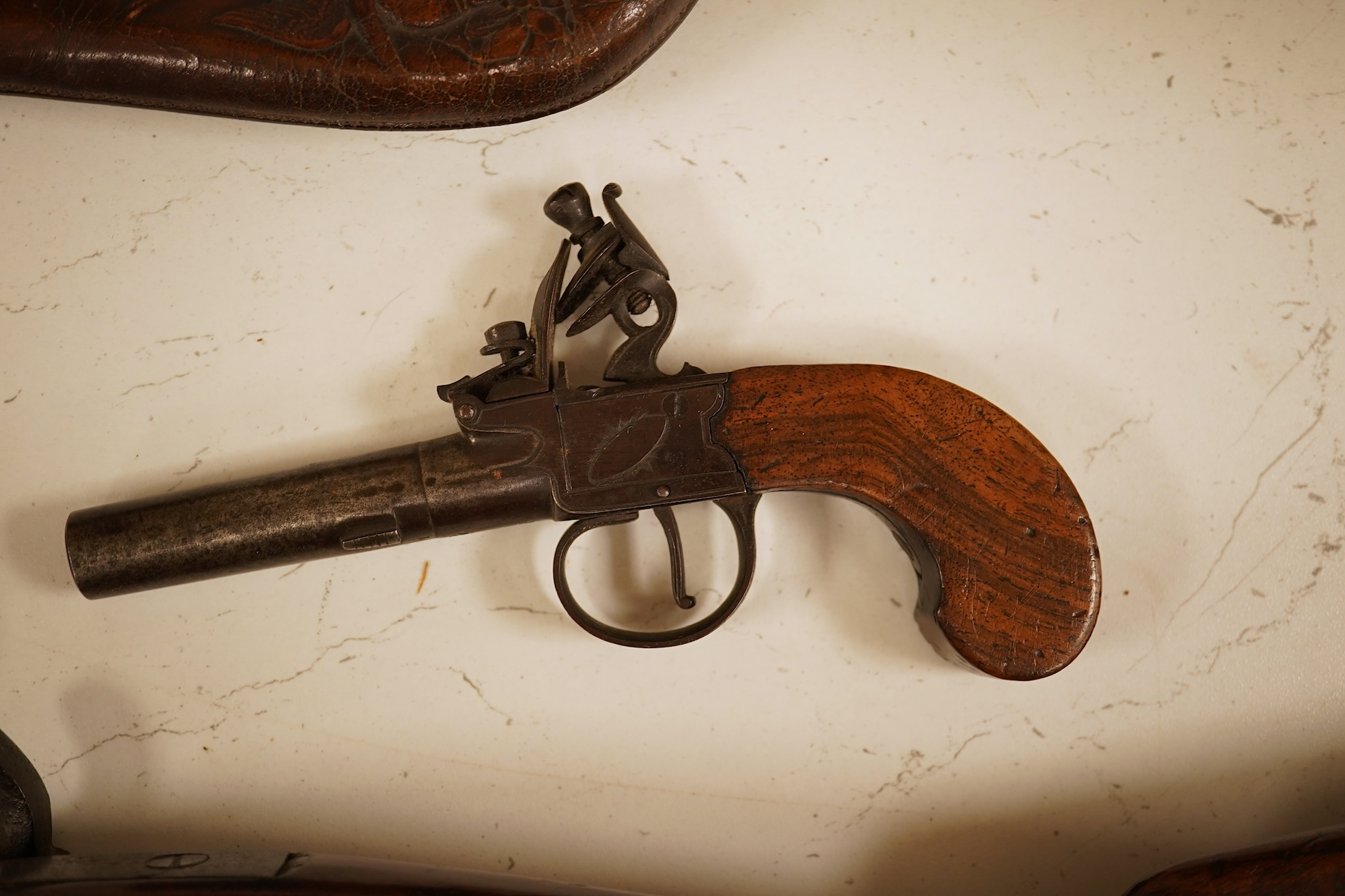 A pair of 19th century pocket pistols, shot flask and a brass musket, 81cm in length